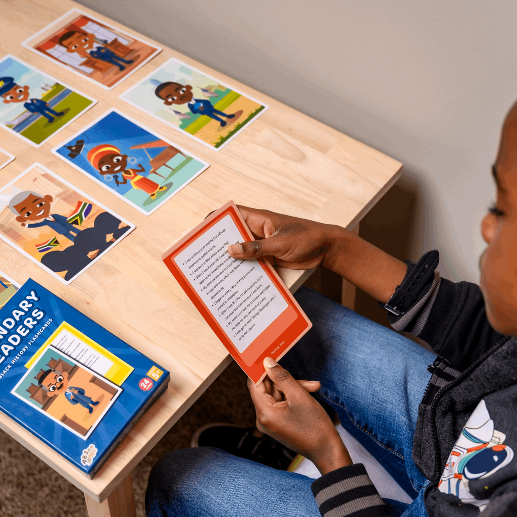 Close-up of African American boy reading Black History Month facts about famous Black inventors from ABSee Me's Legendary Leaders - Black History Flashcards. Used during Black History Month activities for elementary students.